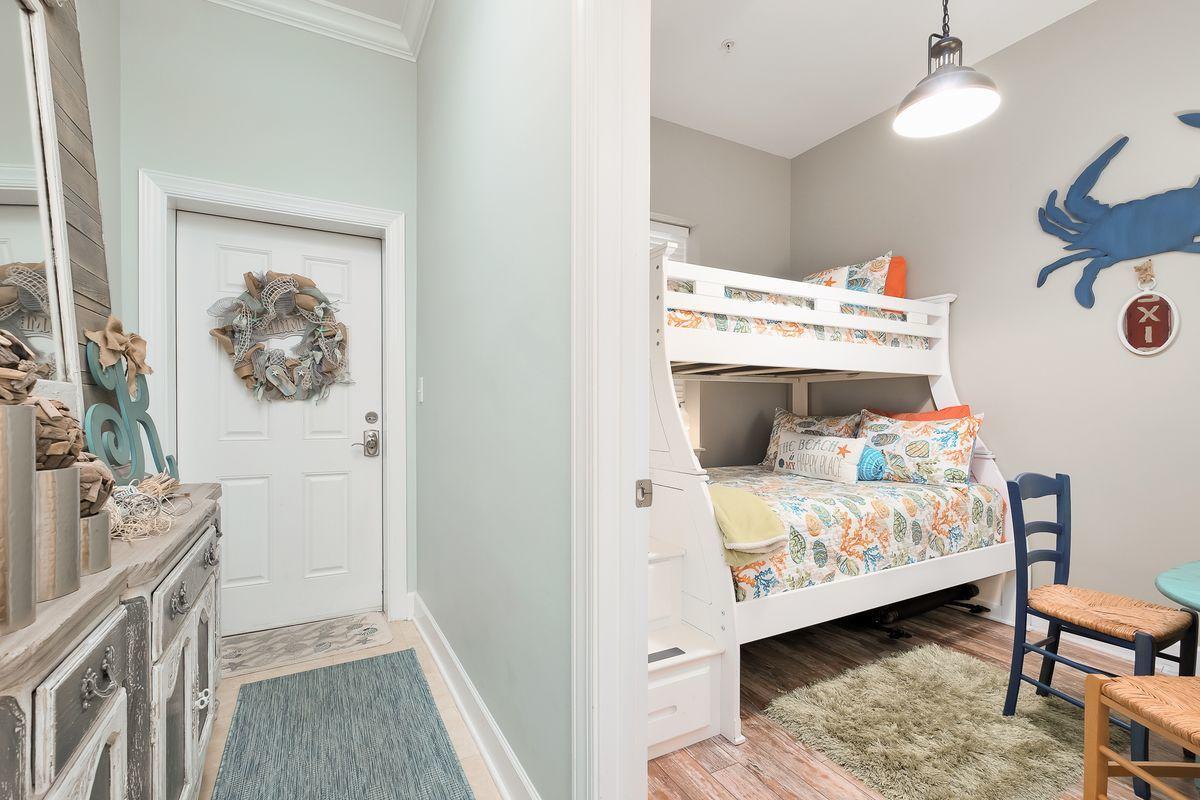 231 Somerset Bridge Road, Unit 2205 Santa Rosa Beach, FL 32459 - Photo 8 of 40 a bedroom with a bed and wooden floor