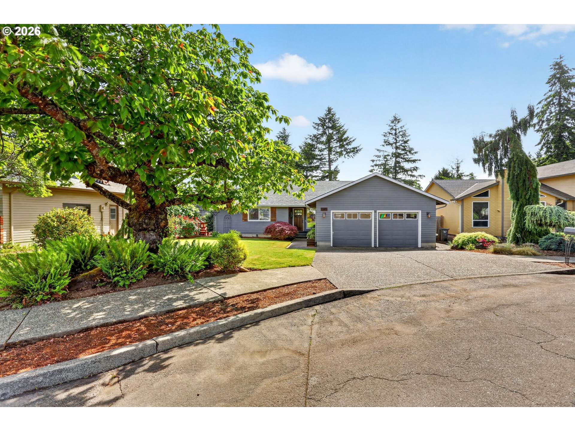 1776 Southeast 114th Place Portland, OR 97216 - Photo 6 of 47 a front view of a house with a yard and garage