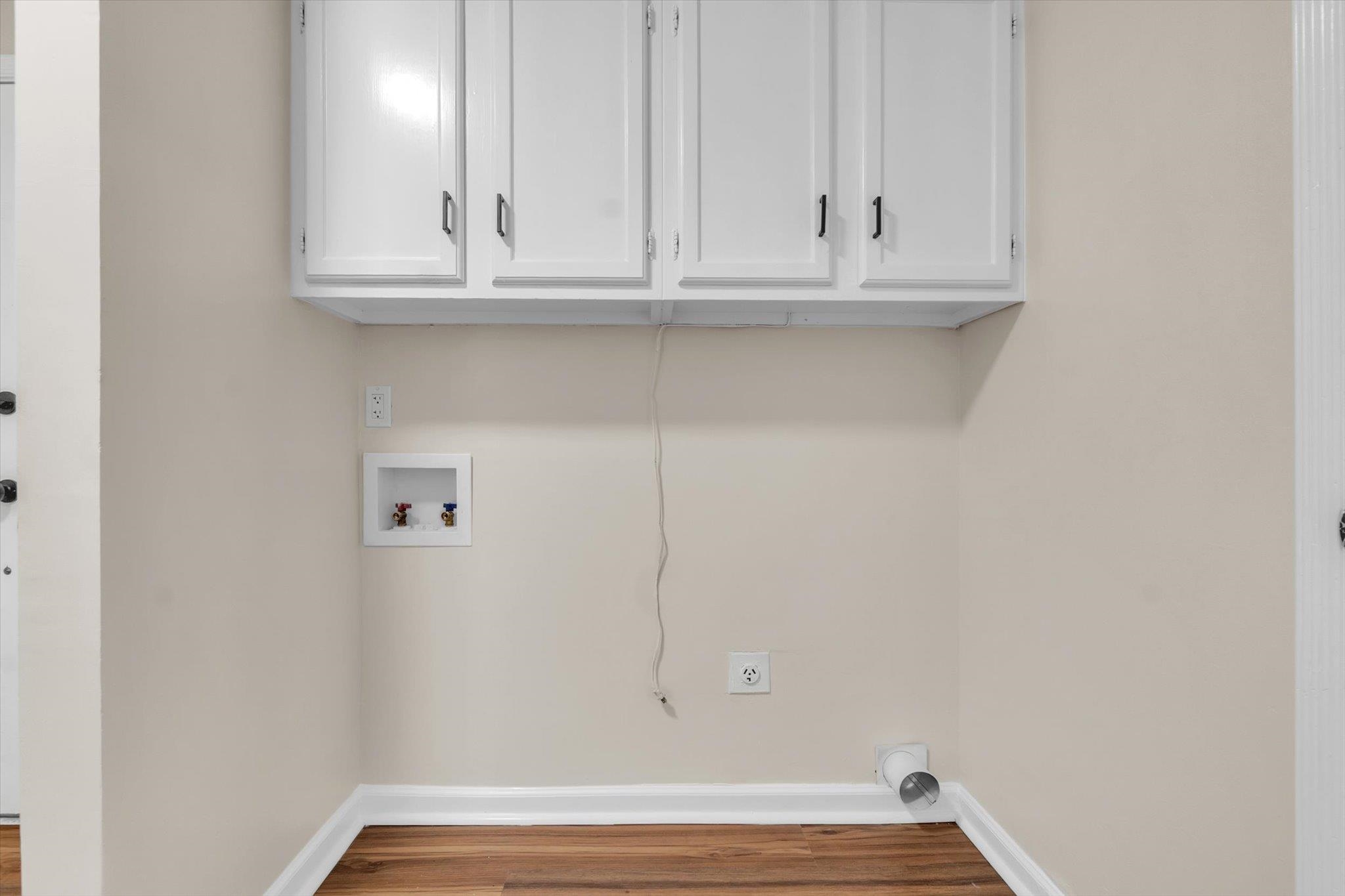 5509 Rappahannock Drive Memphis, TN 38134 - Photo 13 of 27 Laundry area with cabinet space, hookup for a washing machine, and wood finished floors