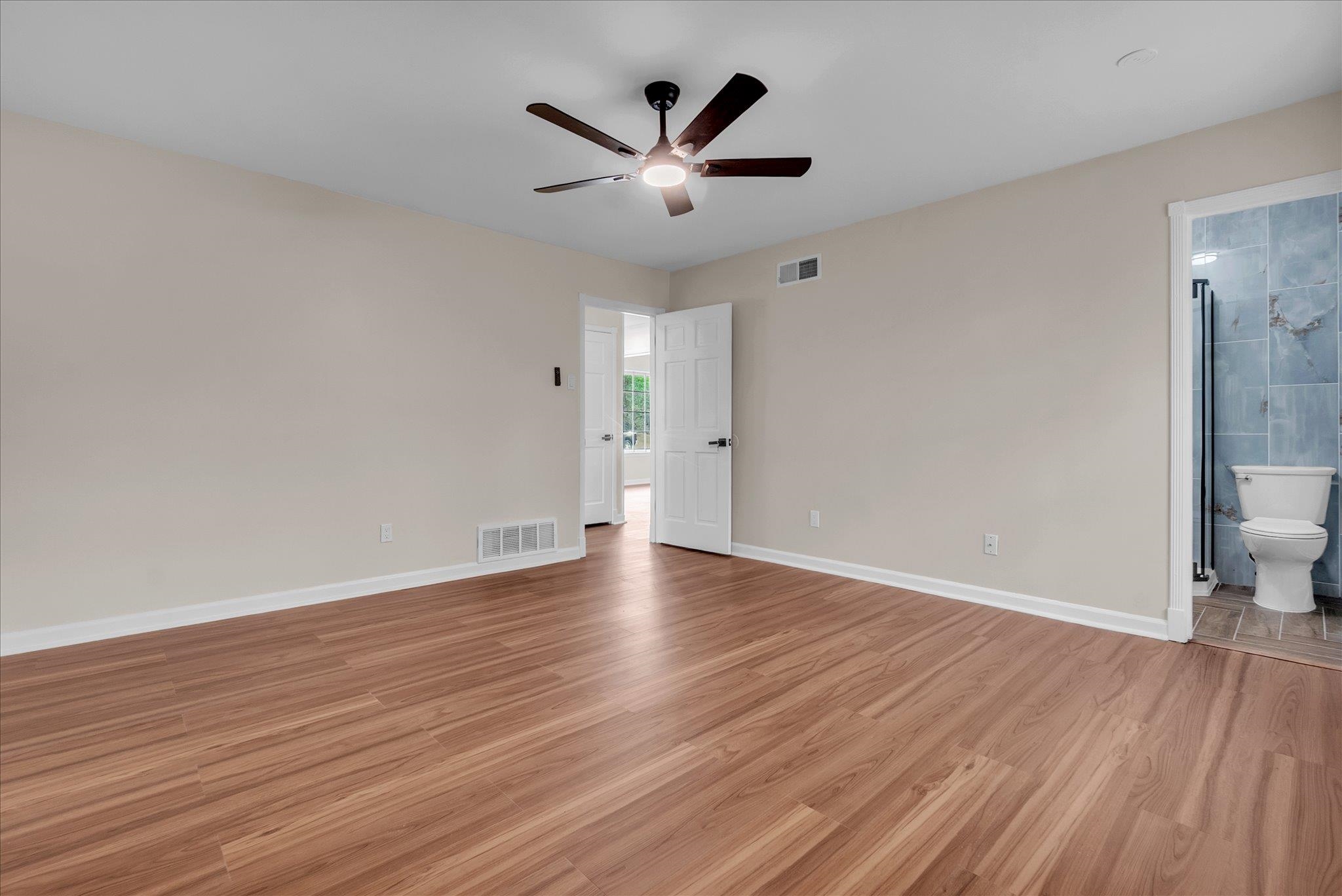 5509 Rappahannock Drive Memphis, TN 38134 - Photo 20 of 27 Unfurnished bedroom with light wood-type flooring, ceiling fan, and connected bathroom