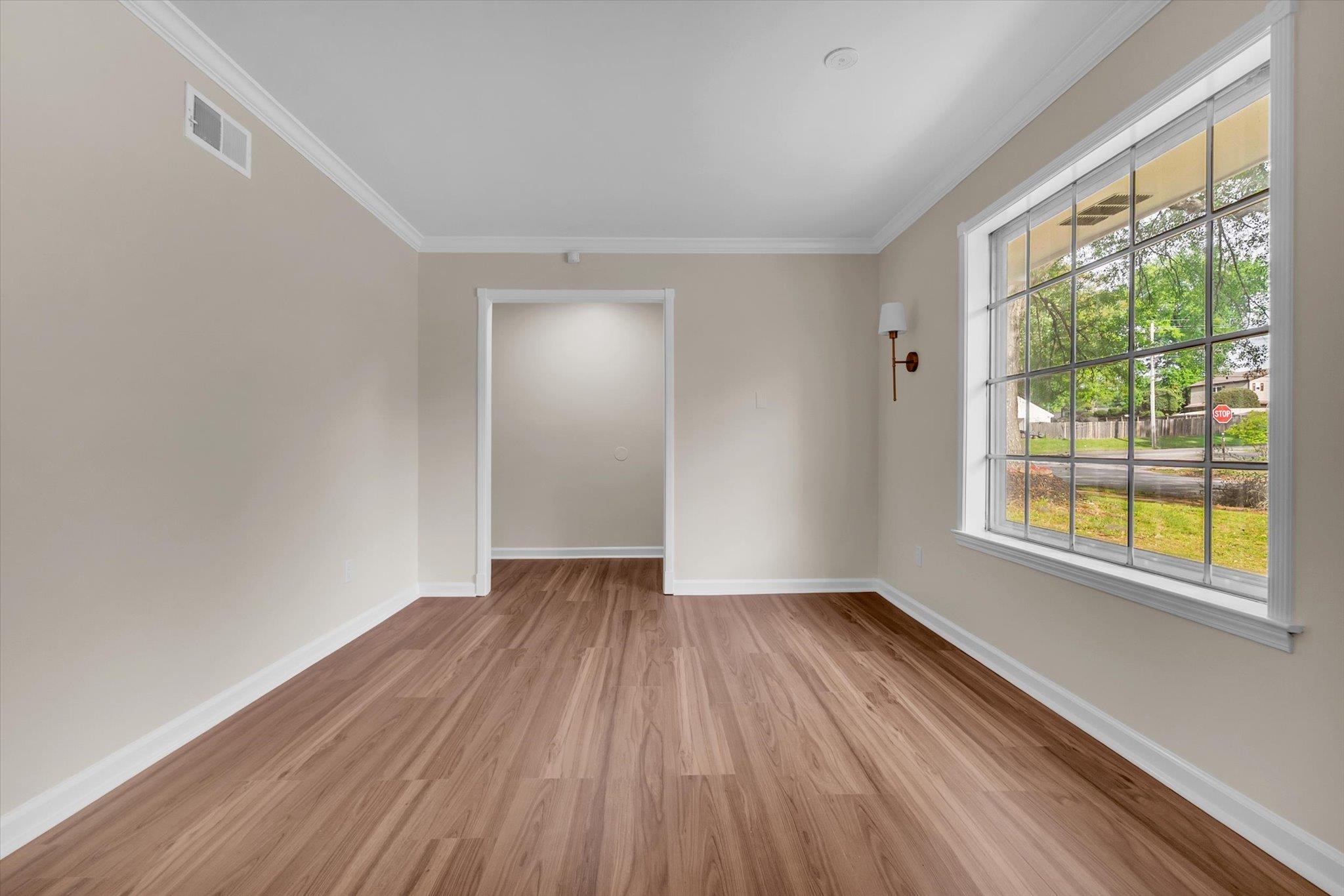 5509 Rappahannock Drive Memphis, TN 38134 - Photo 6 of 27 Empty room with light wood finished floors and ornamental molding