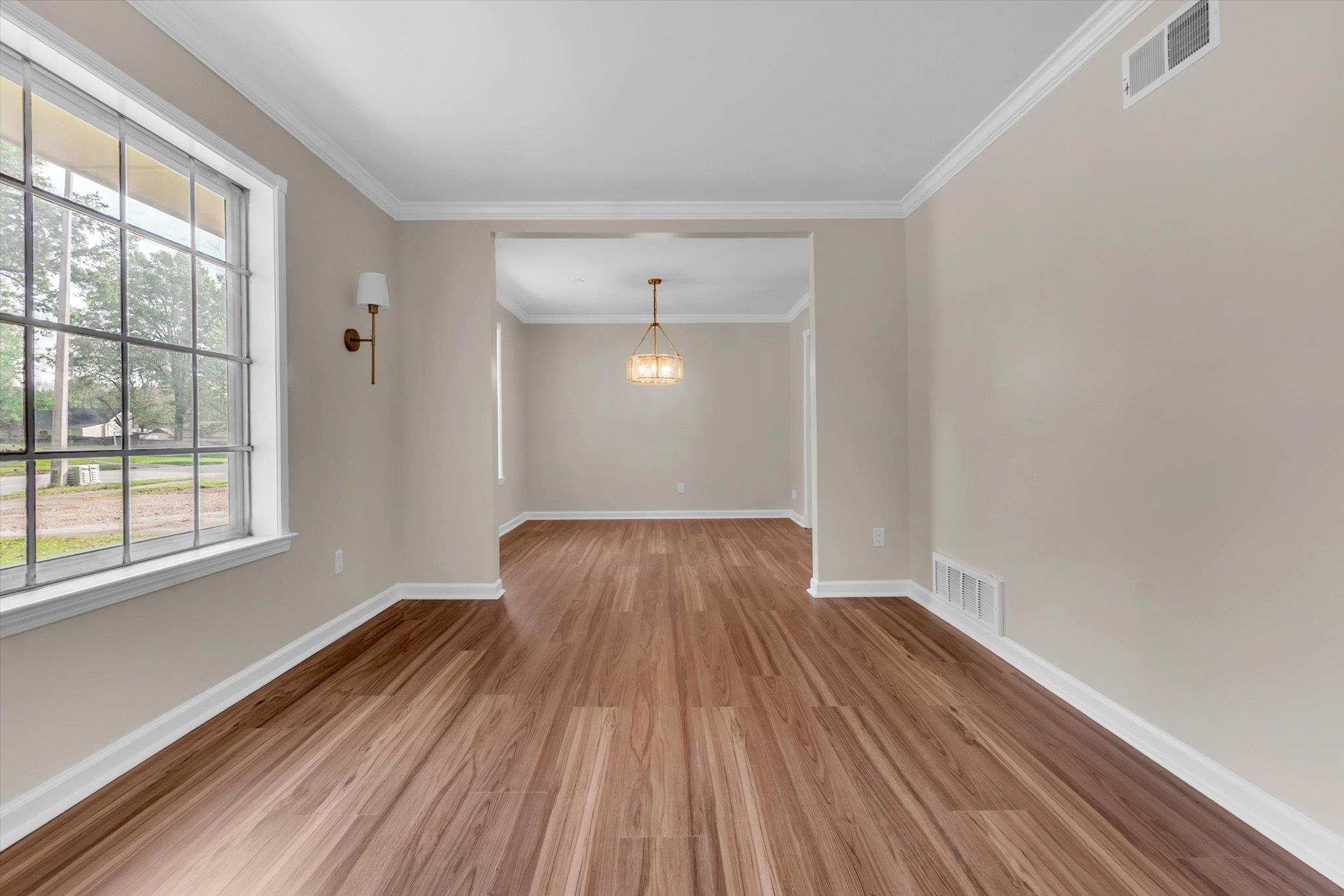 5509 Rappahannock Drive Memphis, TN 38134 - Photo 7 of 27 Spare room featuring light wood-type flooring and crown molding