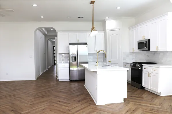 a kitchen with refrigerator and microwave