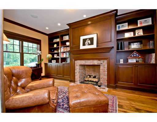 79 Stephen Mather Road Darien, CT 06820 - Photo 9 of 20 a living room with furniture a fireplace and a bookshelf