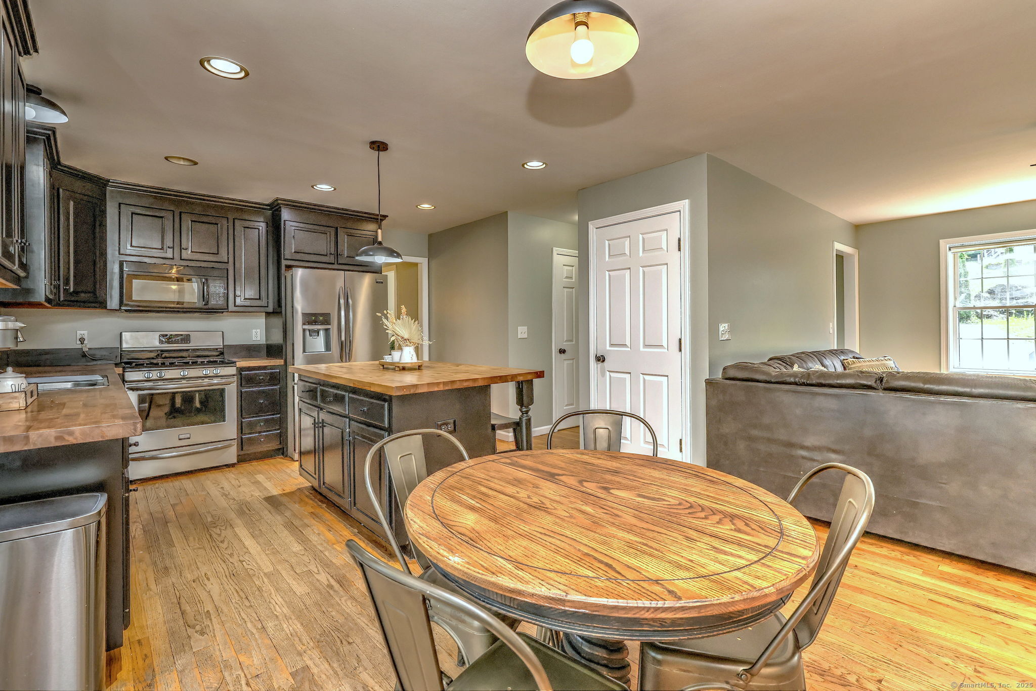 28 Edgewood Avenue Shelton, CT 06484 - Photo 15 of 40 a kitchen with stainless steel appliances granite countertop a stove a sink a dining table and chairs