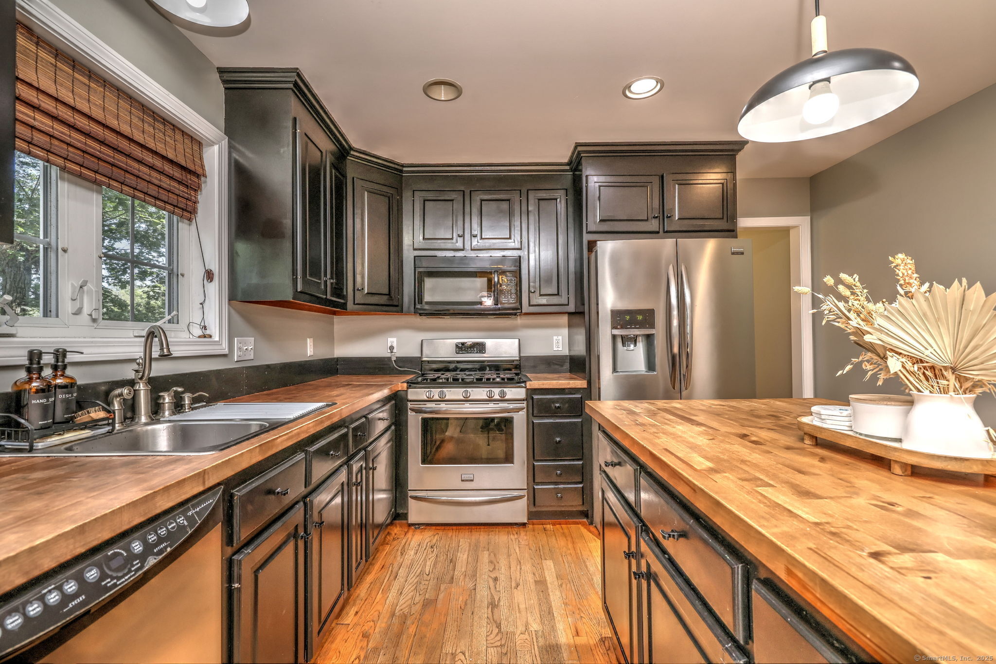 28 Edgewood Avenue Shelton, CT 06484 - Photo 16 of 40 a kitchen with stainless steel appliances granite countertop a sink stove and refrigerator