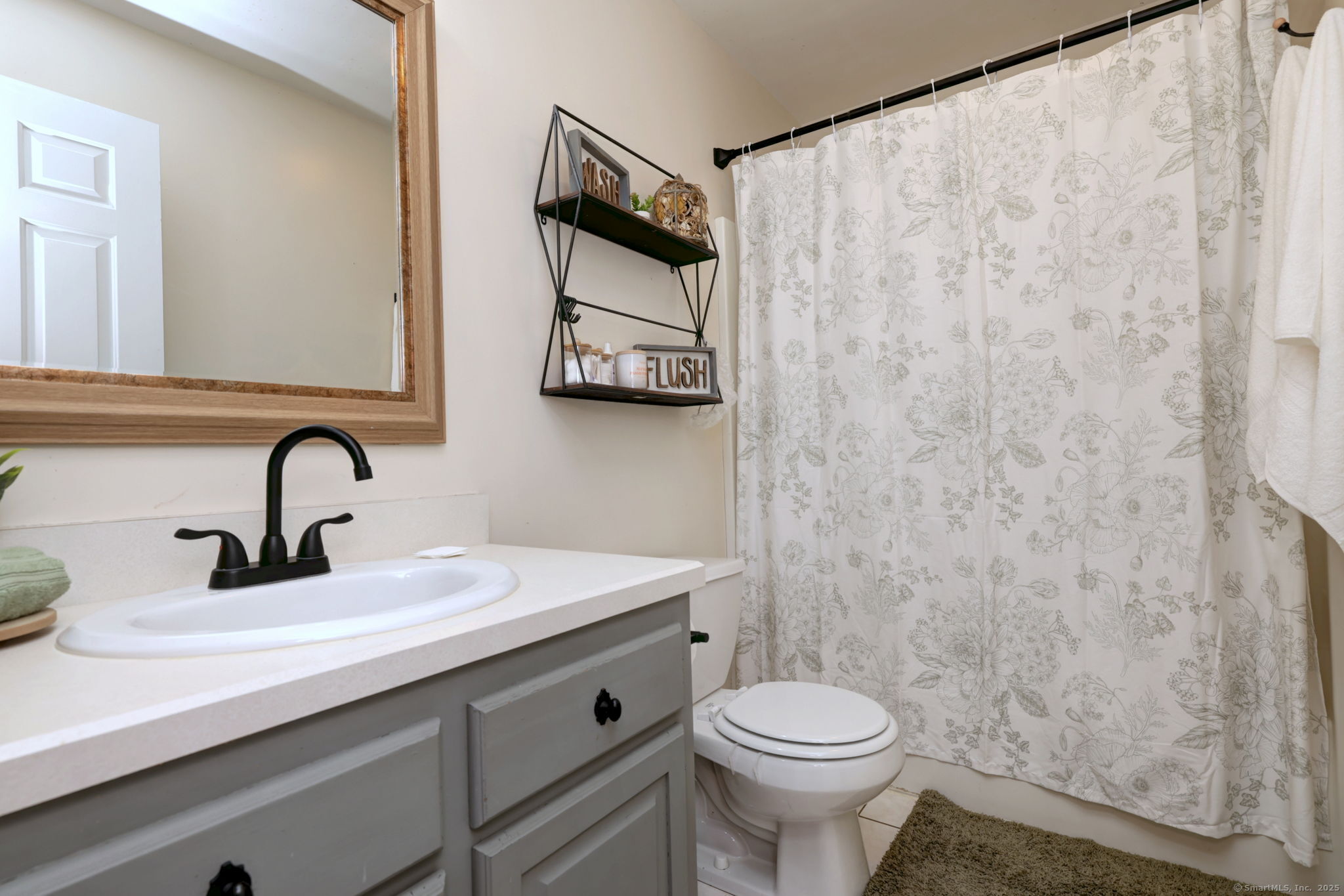 28 Edgewood Avenue Shelton, CT 06484 - Photo 30 of 40 a bathroom with a sink a toilet and a mirror