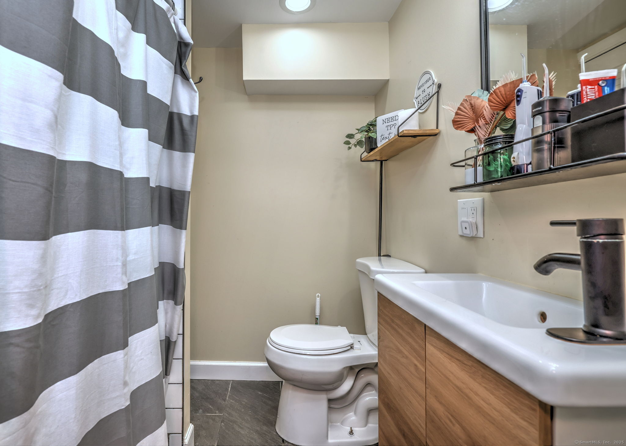 28 Edgewood Avenue Shelton, CT 06484 - Photo 37 of 40 a bathroom with a sink a toilet and a mirror