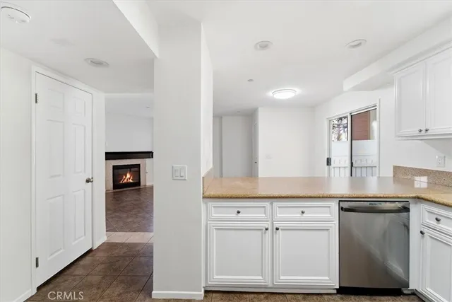 a kitchen with white cabinets and sink