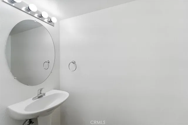 a bathroom with a sink and mirror