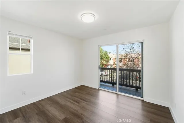 a view of a room with wooden floor and windows