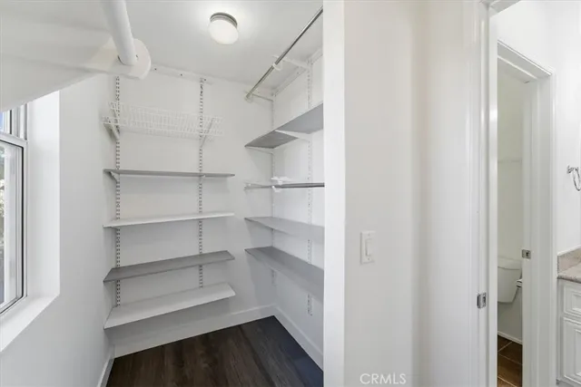 a view of walk in closet with empty racks
