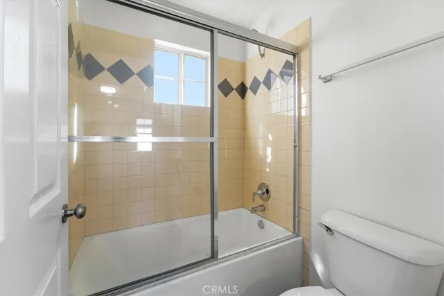 a bathroom with a shower and a toilet