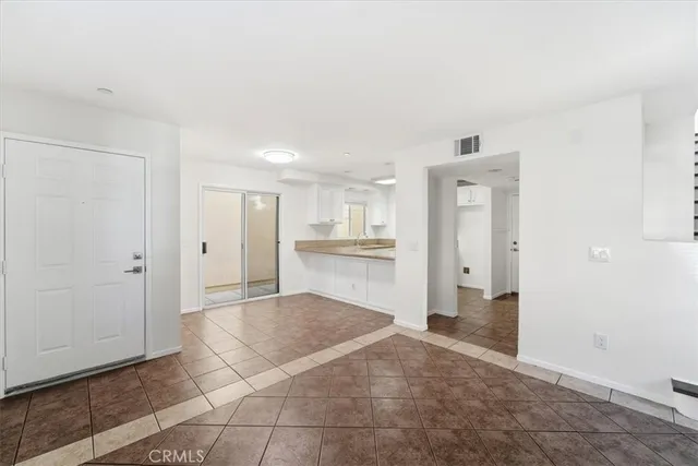 a view of a kitchen with refrigerator and microwave