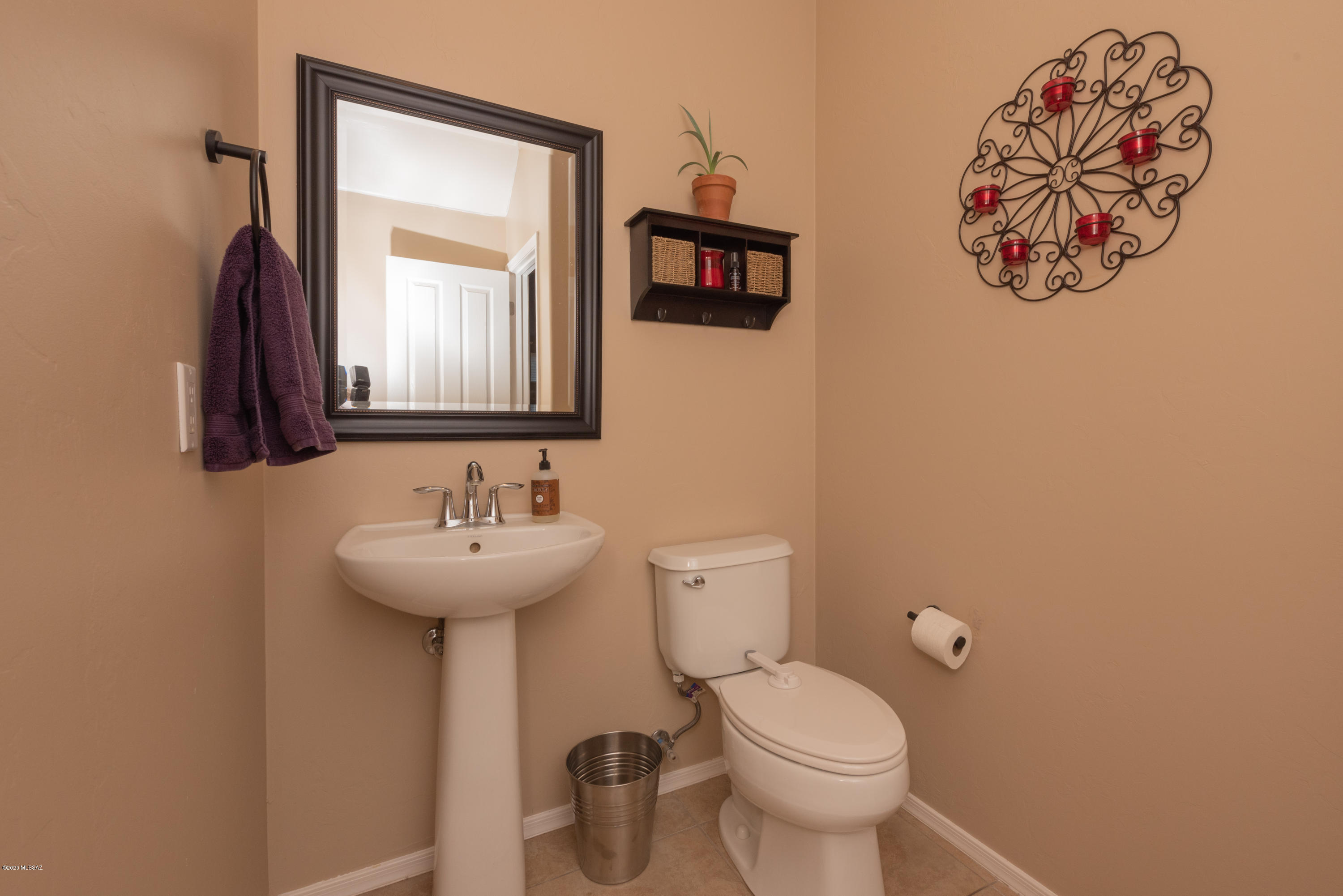 12910 Bloomington Loop Oro Valley, AZ 85755 - Photo 15 of 30 a bathroom with a toilet sink and mirror