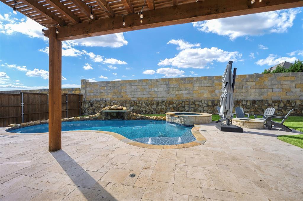 1220 Packsaddle Trail Prosper, TX 75078 - Photo 11 of 33 a view of a swimming pool with a couch and wooden fence