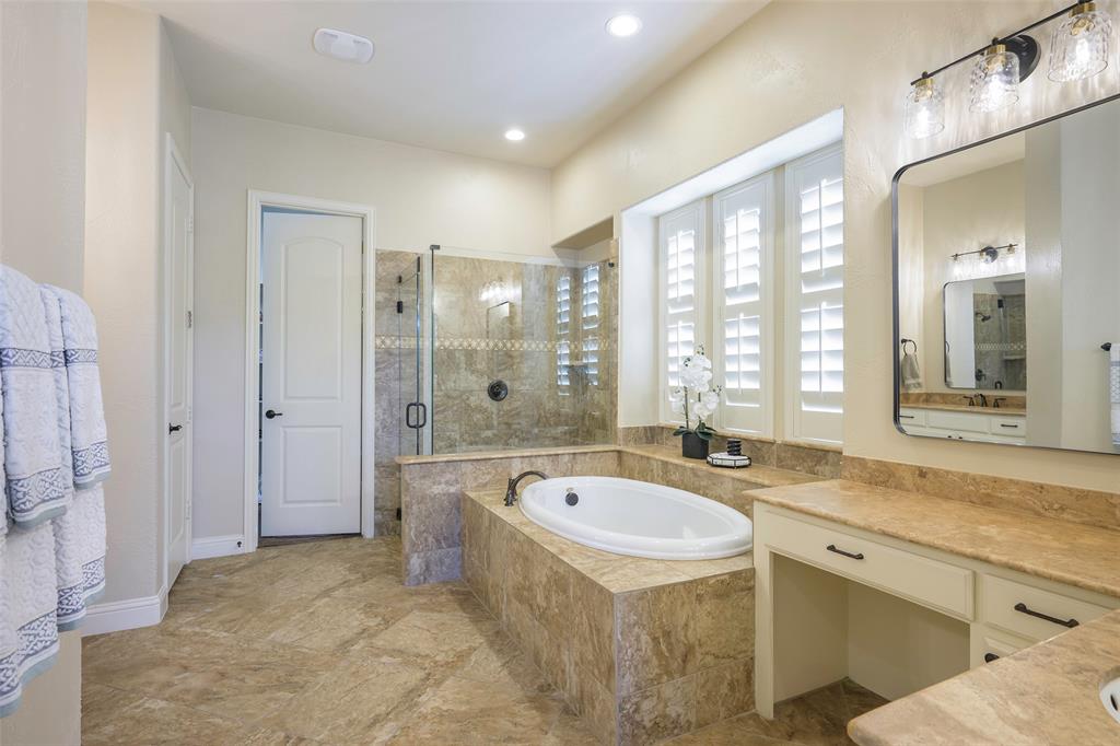 1220 Packsaddle Trail Prosper, TX 75078 - Photo 18 of 33 a spacious bathroom with a tub sink shower and mirror