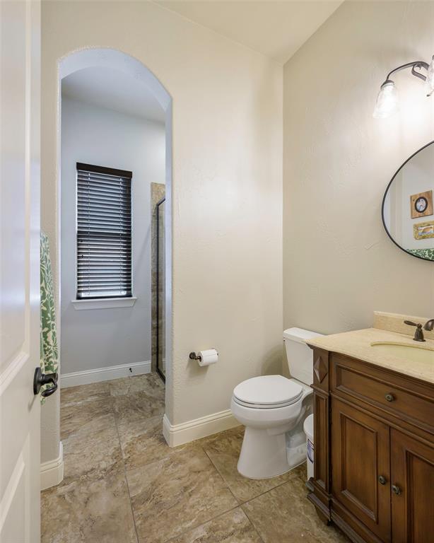 1220 Packsaddle Trail Prosper, TX 75078 - Photo 21 of 33 a bathroom with a granite countertop toilet and a sink