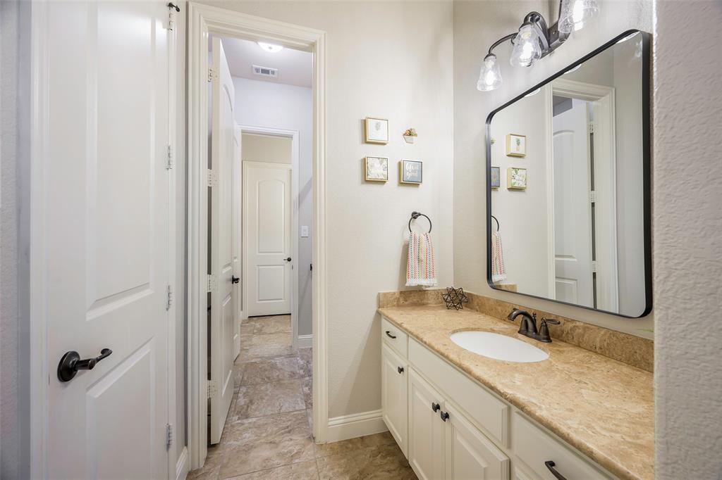 1220 Packsaddle Trail Prosper, TX 75078 - Photo 26 of 33 a bathroom with a granite countertop sink and a mirror