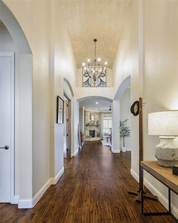 1220 Packsaddle Trail Prosper, TX 75078 - Photo 3 of 33 a view of a room with wooden floor and chandelier