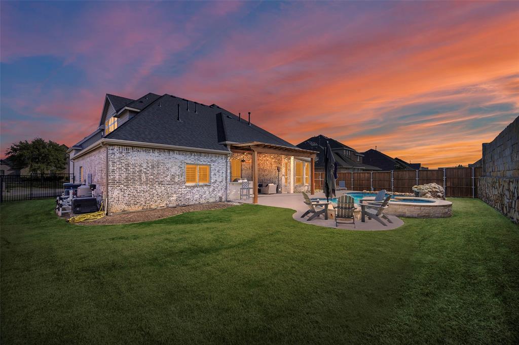 1220 Packsaddle Trail Prosper, TX 75078 - Photo 30 of 33 a backyard of a house with table and chairs