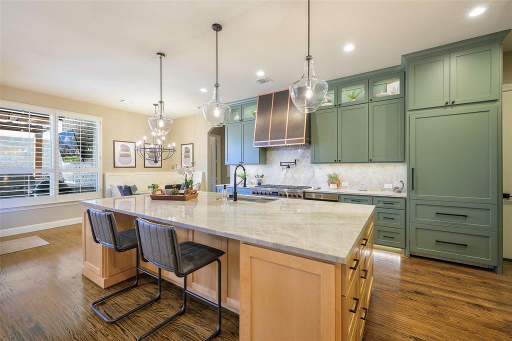 1220 Packsaddle Trail Prosper, TX 75078 - Photo 4 of 33 a kitchen with a table chairs sink and cabinets