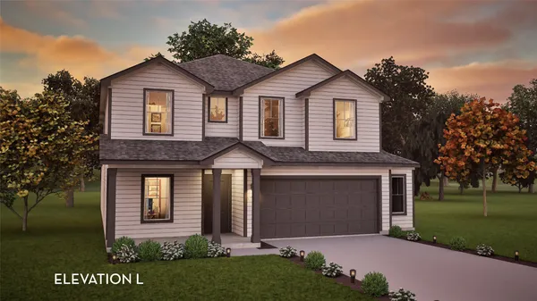 a front view of a house with a garden and yard