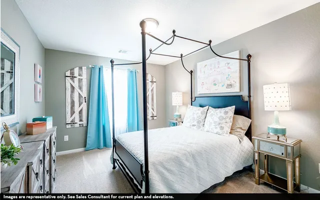 a bedroom with a bed a flat screen tv and a chandelier