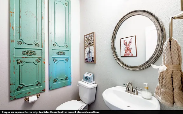 a bathroom with a toilet a sink and a mirror