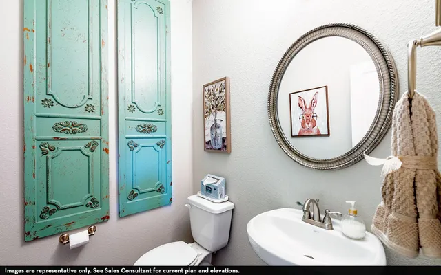 a bathroom with a toilet a sink and a mirror