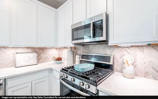 a kitchen with granite countertop a stove and a wooden floor