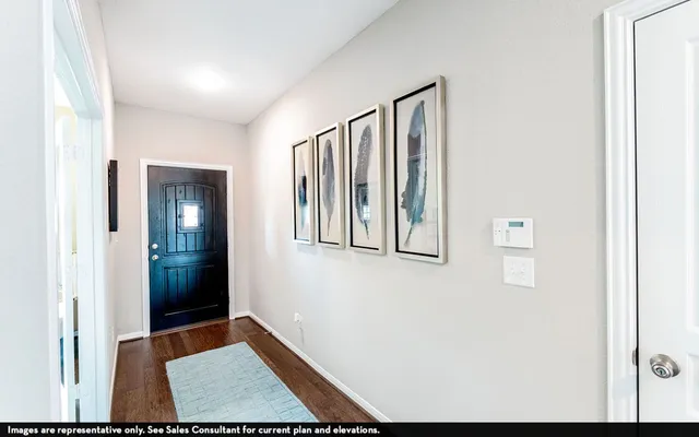 a view of an entryway with wooden floor