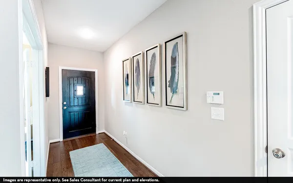 a view of an entryway with wooden floor