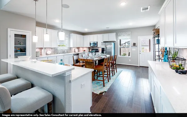 a living room with stainless steel appliances kitchen island granite countertop lots of furniture and wooden floors