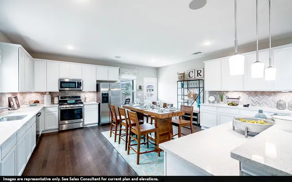 a kitchen with stainless steel appliances kitchen island granite countertop a stove top oven a sink a dining table and chairs
