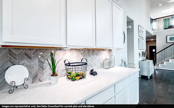 a kitchen with a sink a stove and cabinets