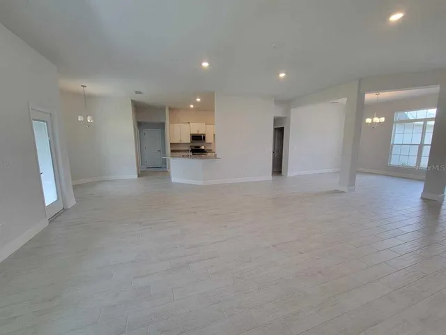 an empty room with a empty space and windows