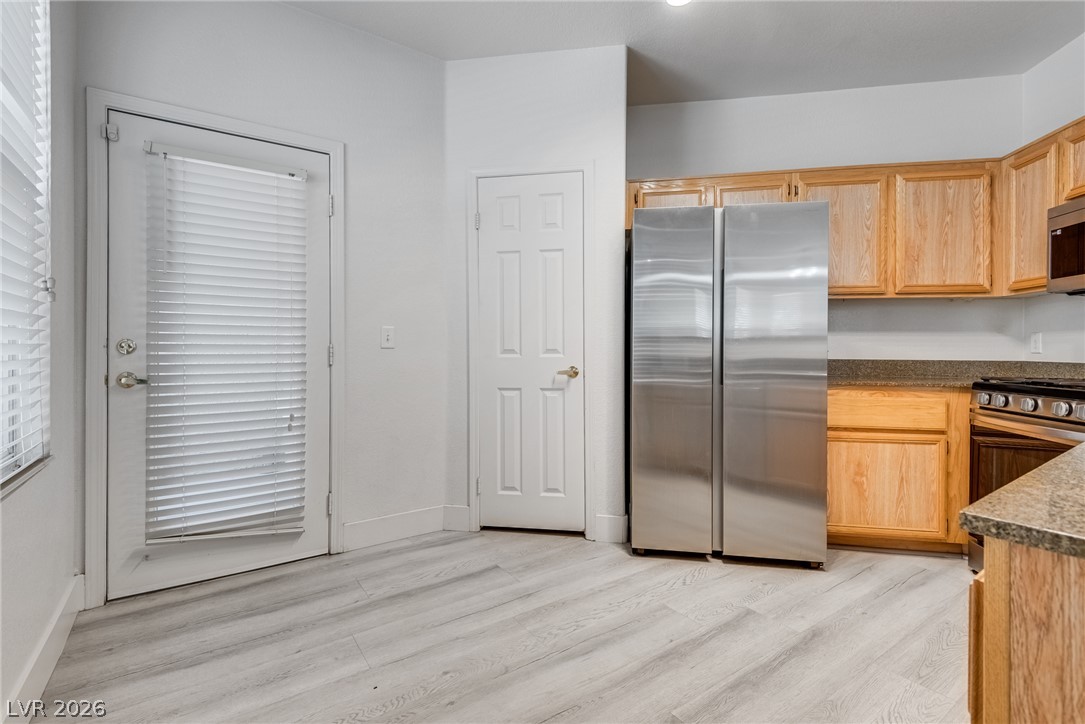 10550 West Alexander Road, Unit 1139 Las Vegas, NV 89129 - Photo 9 of 27 A well-equipped kitchen features light wood cabinetry, stainless steel appliances, and durable wood-look flooring.