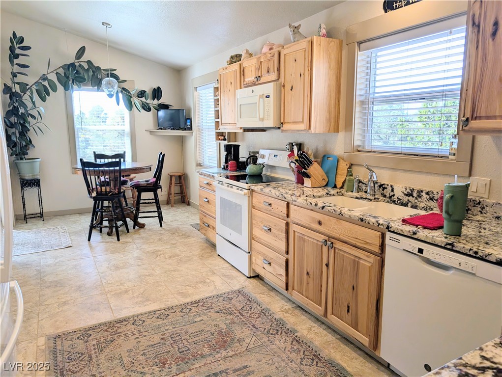 8320 Mother Lode Road Pioche, NV 89043 - Photo 28 of 46 Kitchen with plenty of natural light, hickory cabinetry, and granite counters