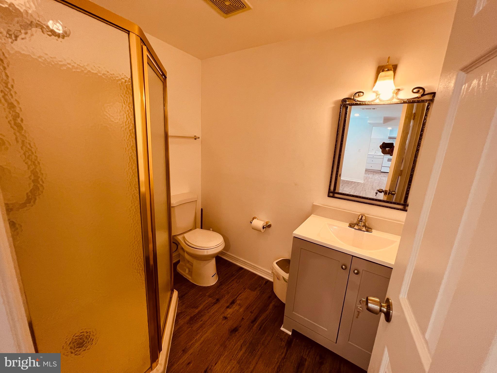11814 Mentone Road Silver Spring, MD 20906 - Photo 11 of 12 a bathroom with a sink a toilet and mirror