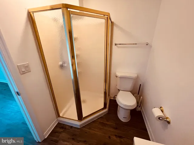 a bathroom with a toilet and a shower