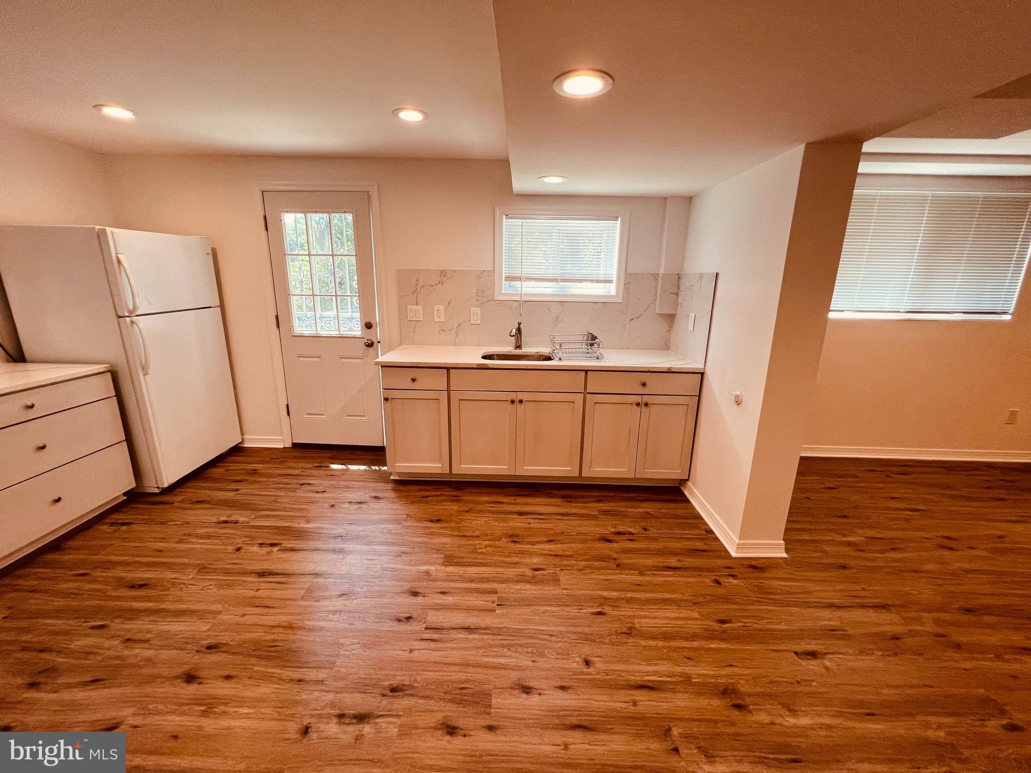 11814 Mentone Road Silver Spring, MD 20906 - Photo 2 of 12 a kitchen with stainless steel appliances granite countertop a refrigerator a stove and a wooden floors