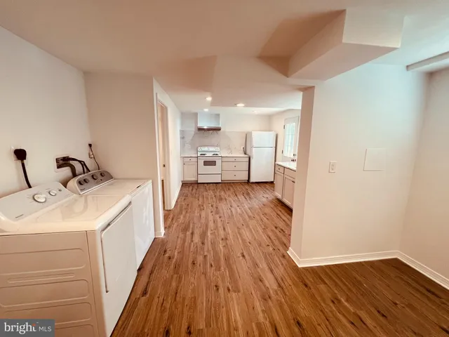 a view of a kitchen with sink and wooden floor