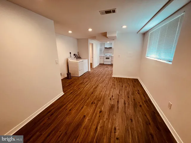 a view of a room with wooden floor and staircase