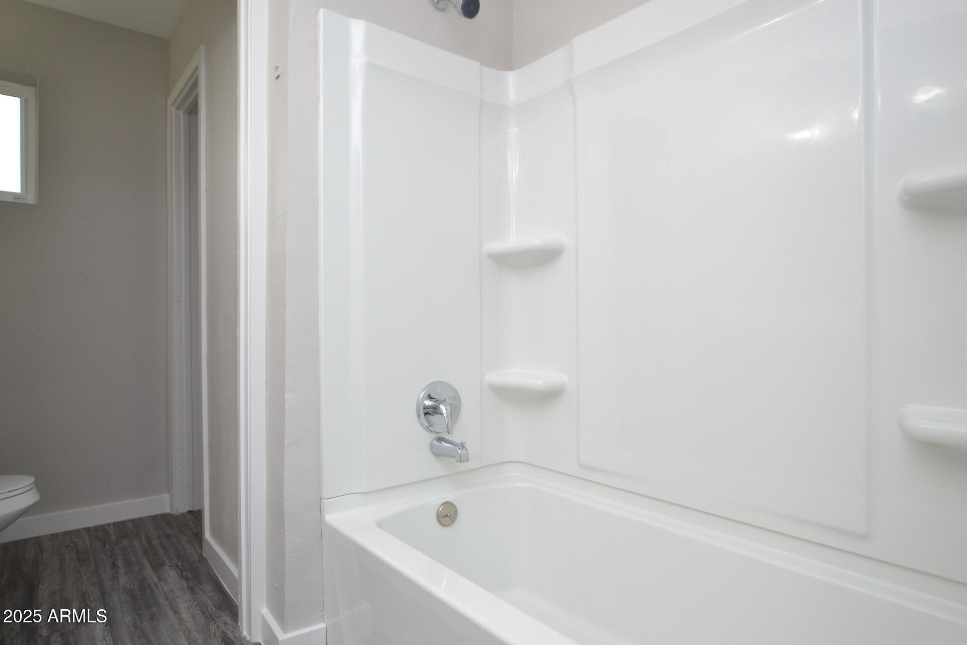 2202 West Devonshire Avenue, Unit 3 Phoenix, AZ 85015 - Photo 15 of 16 a white bath tub sitting next to a white toilet