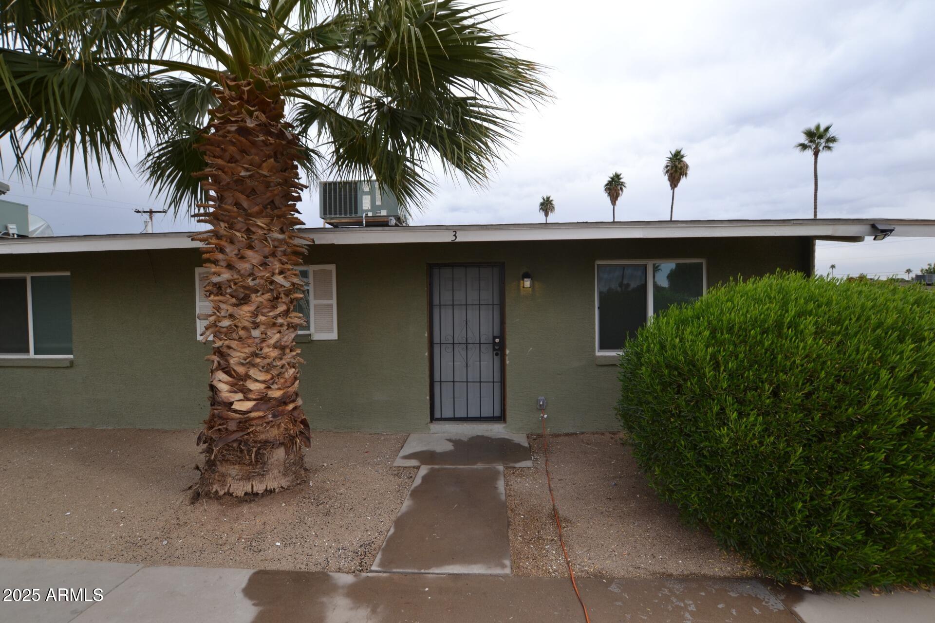 2202 West Devonshire Avenue, Unit 3 Phoenix, AZ 85015 - Photo 2 of 16 a front view of a house with a yard