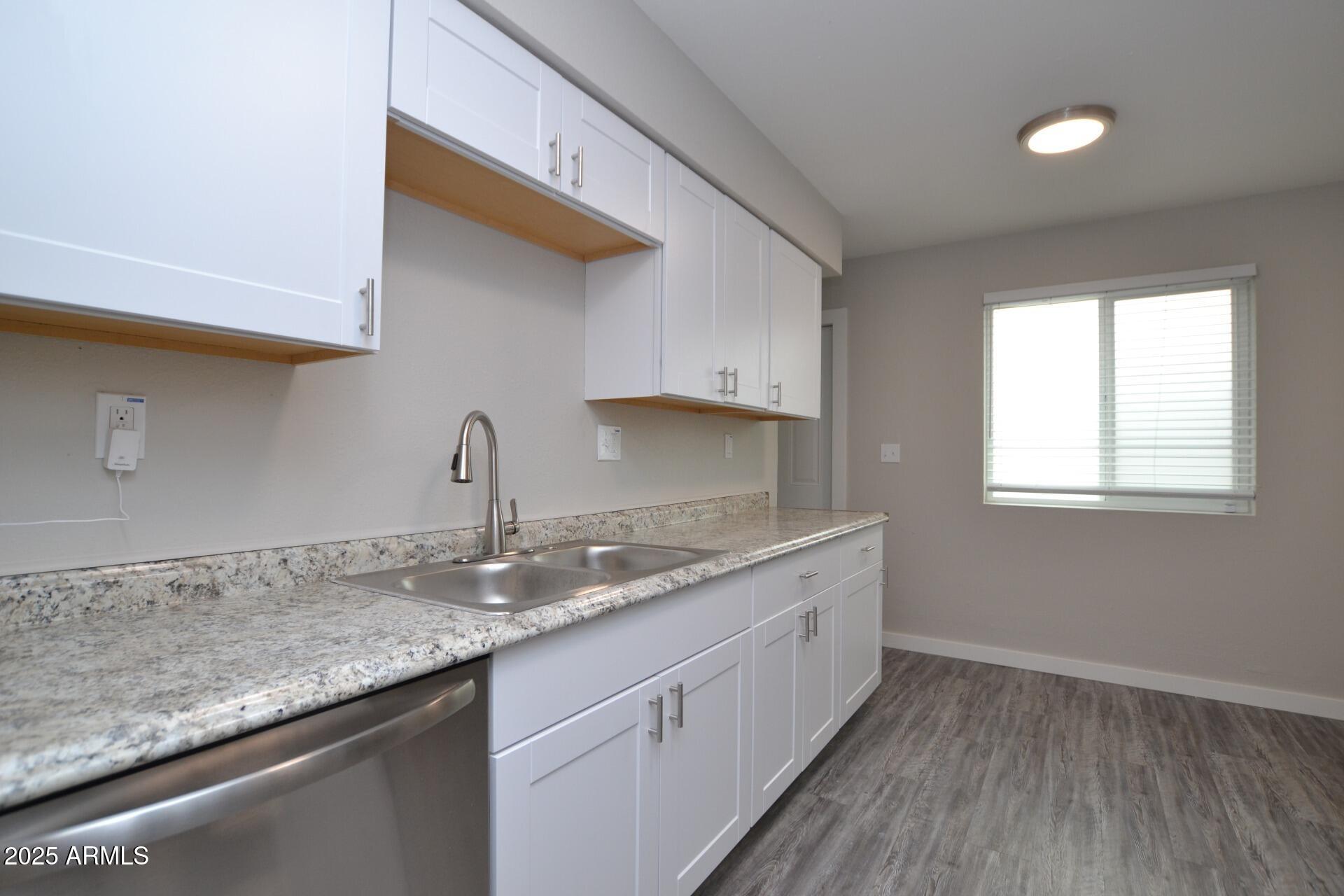 2202 West Devonshire Avenue, Unit 3 Phoenix, AZ 85015 - Photo 6 of 16 a kitchen with granite countertop a sink and cabinets