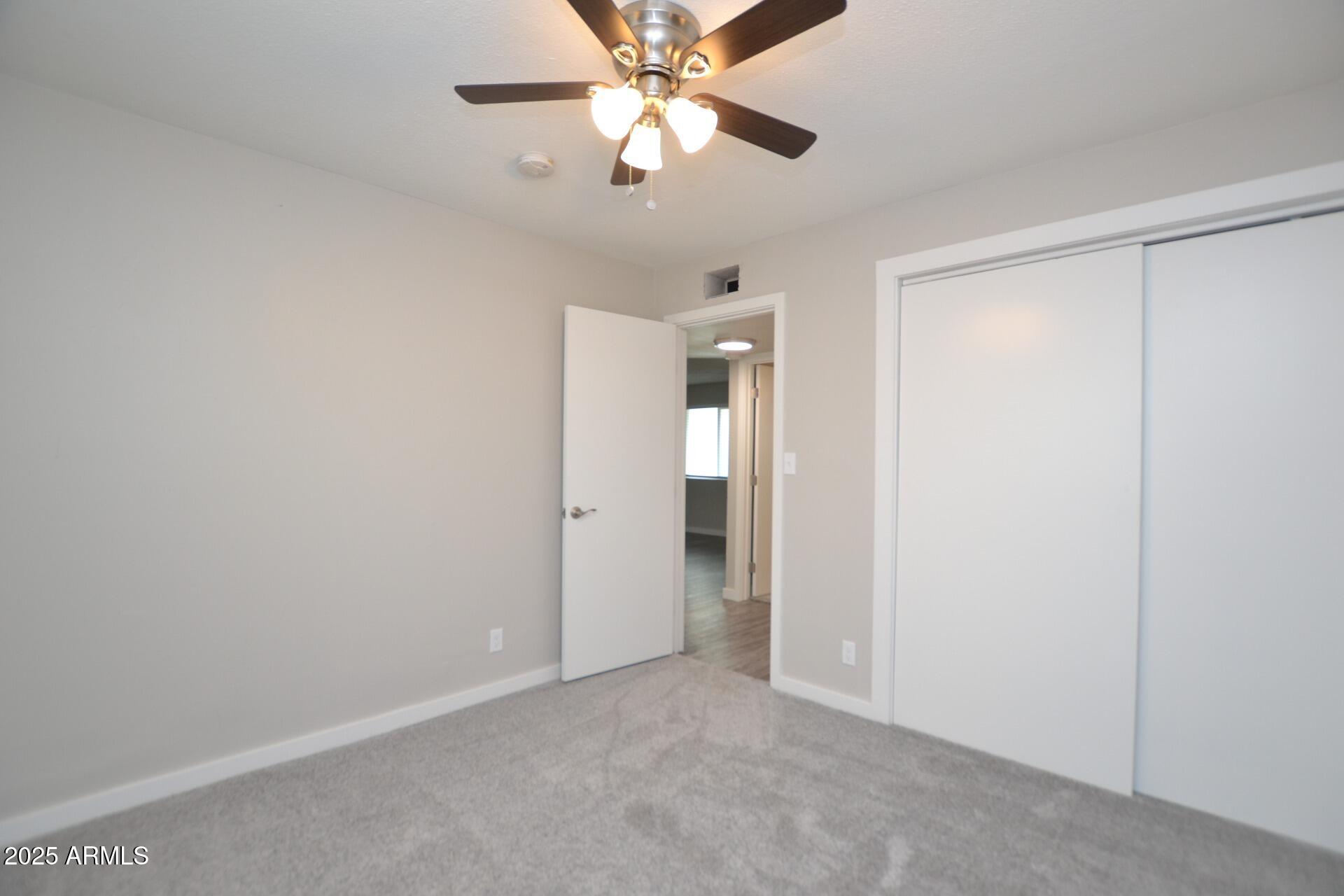 2202 West Devonshire Avenue, Unit 3 Phoenix, AZ 85015 - Photo 10 of 16 a view of an empty room and a ceiling fan