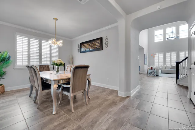 a kitchen with stainless steel appliances kitchen island granite countertop a stove a sink a refrigerator and white cabinets