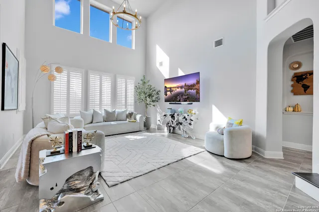 a living room with furniture and kitchen view